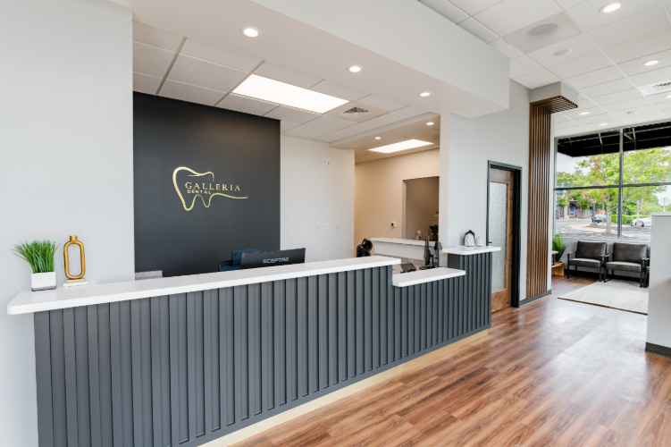 Reception area with desk and Galleria Dental logo.