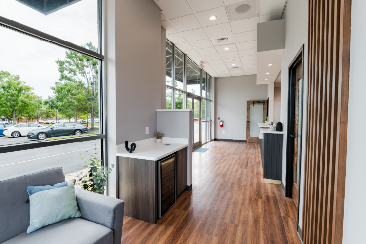 Lobby seating area with windows and decor.