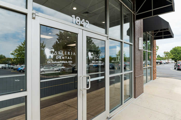 Entrance to Galleria Dental with glass doors and logo.
